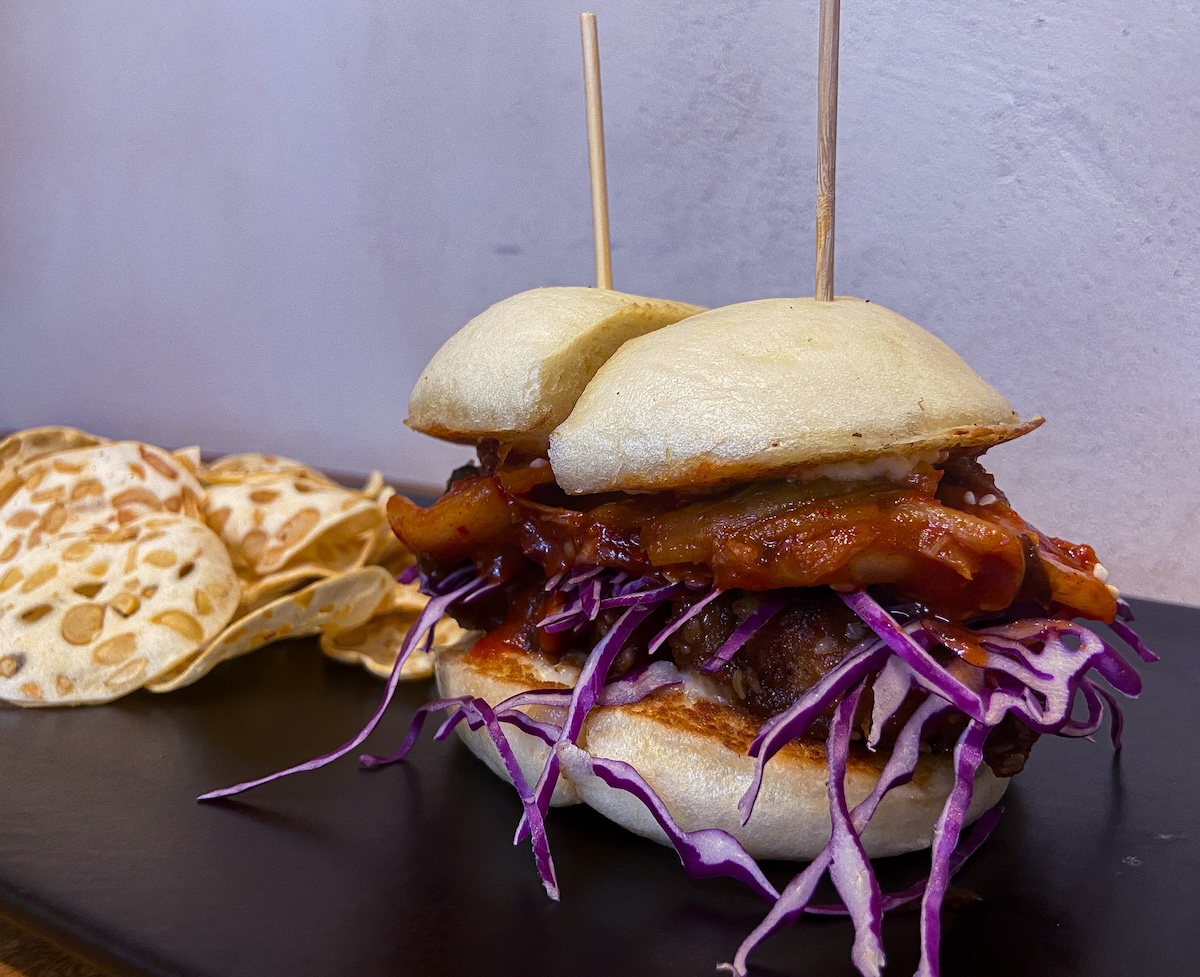 A delicious bulgogi and kimchi bao burger served at a restaurant