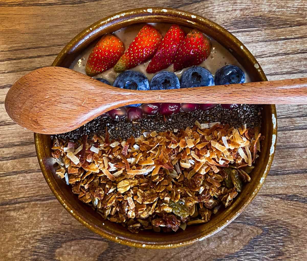 A smoothie bowl topped with fruits and granola