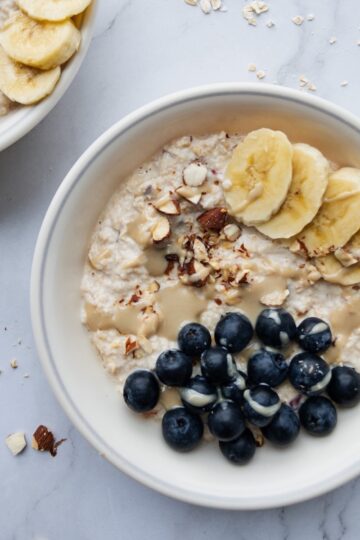 Bircher muesli in a bowl topped with blueberries and banana