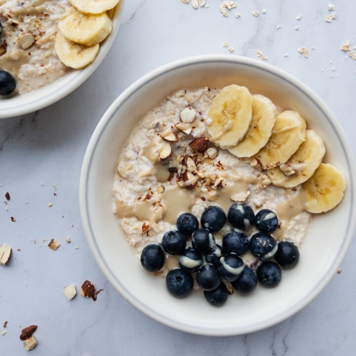 Bircher muesli in a bowl topped with blueberries and banana