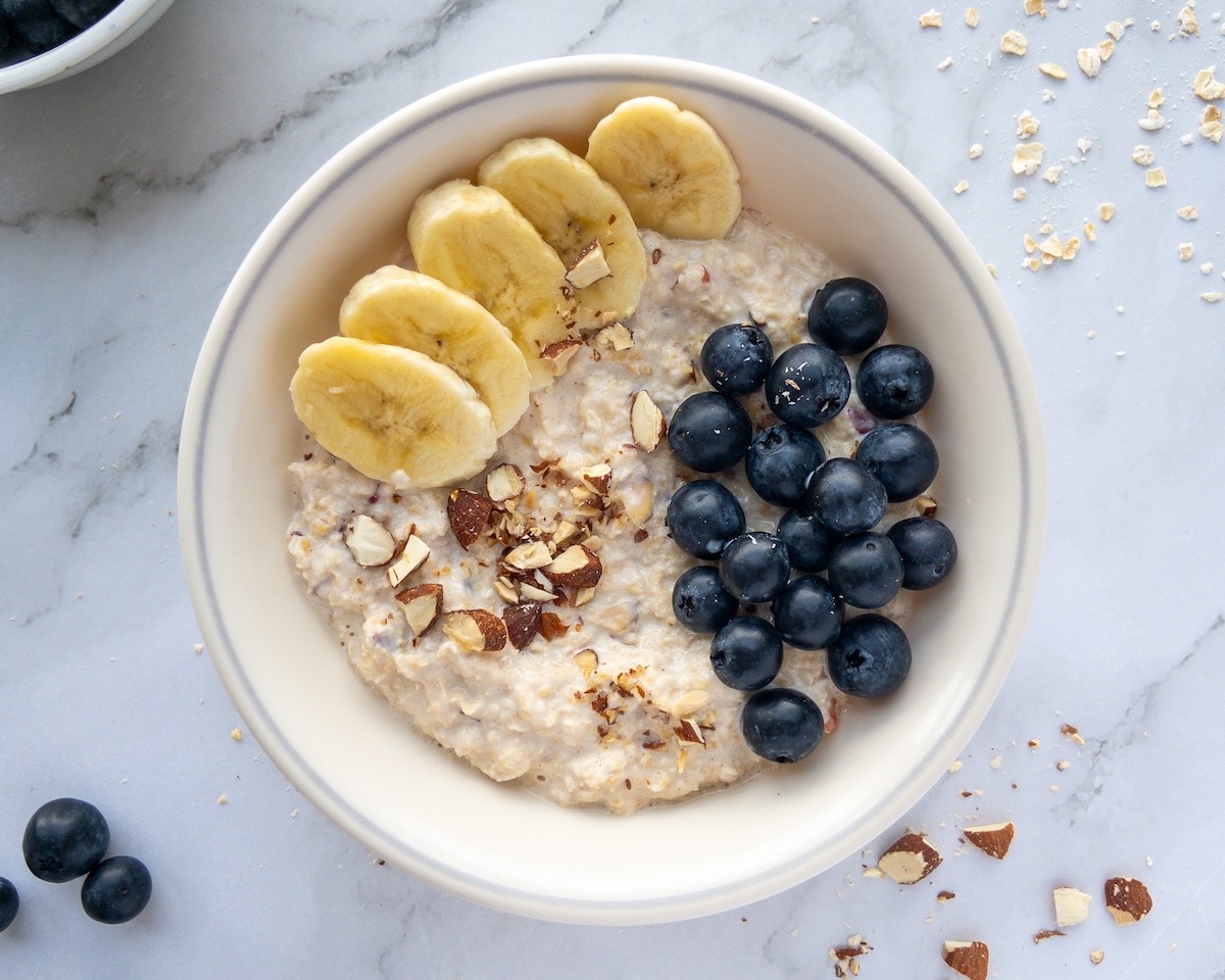 Bircher muesli in a bowl topped with blueberries and banana