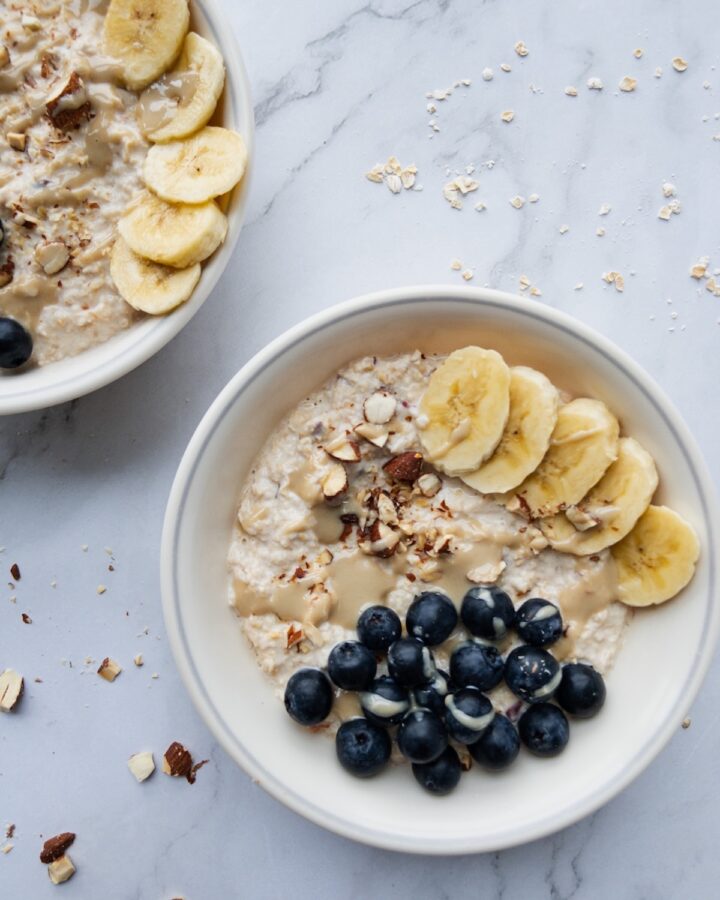Bircher muesli in a bowl topped with blueberries and banana