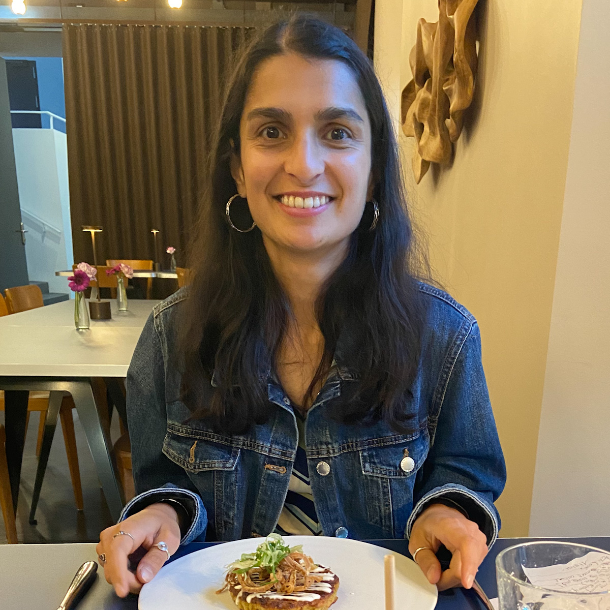 a girl sitting at a table eating food