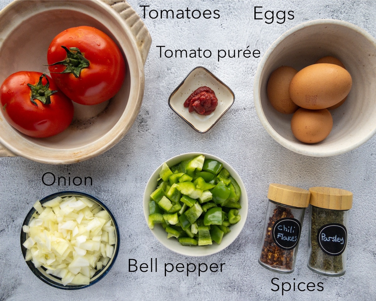 Ingredients for menemen placed in bowls on a table