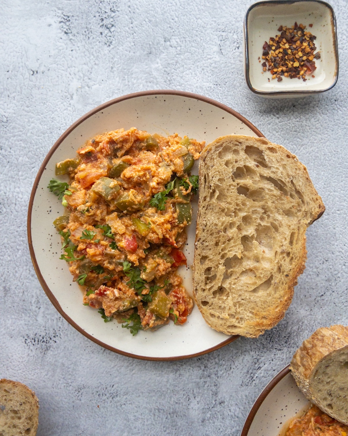 Menemen served with a slice of bread on a plate