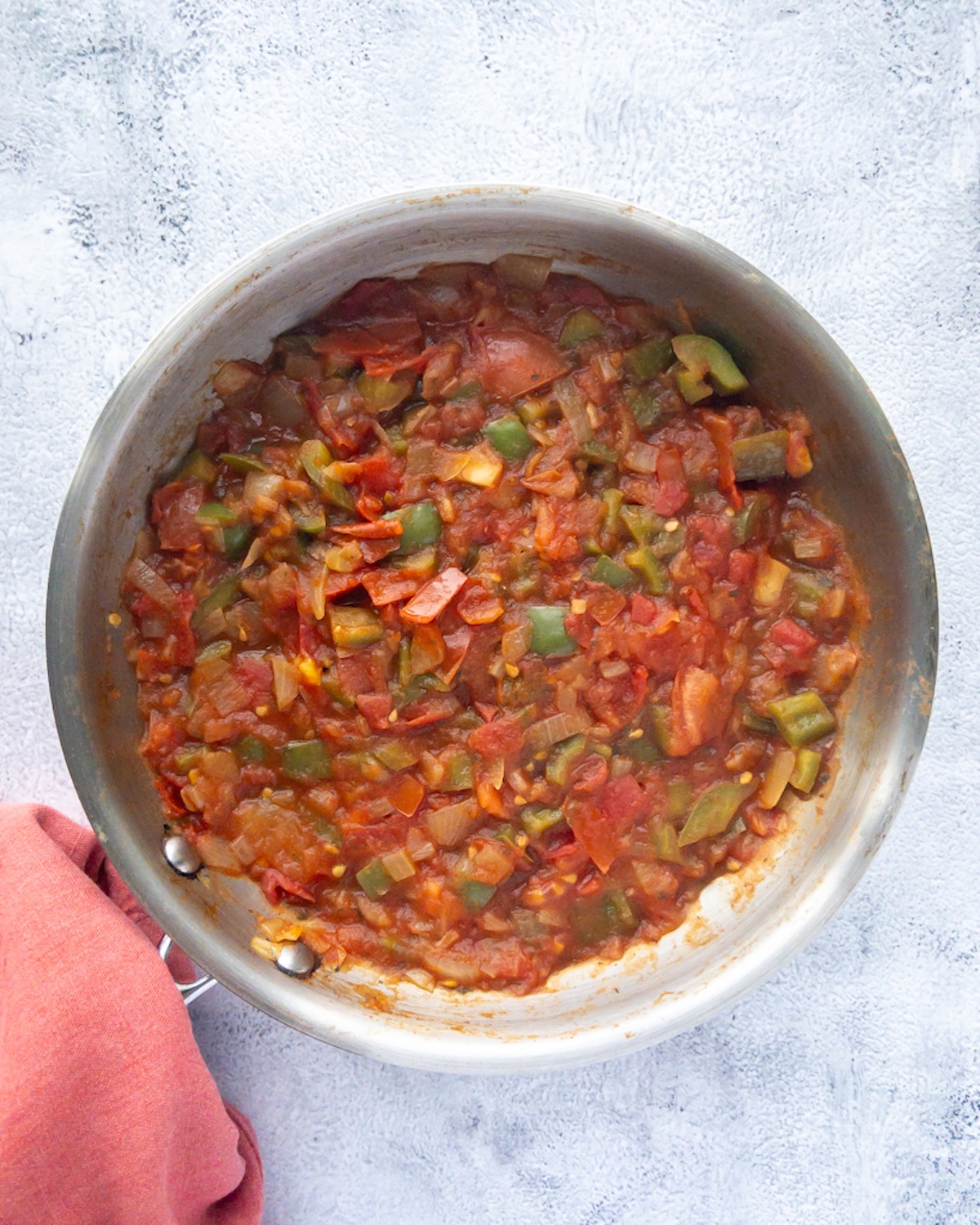 Menemen being made with onions, peppers and tomatoes.