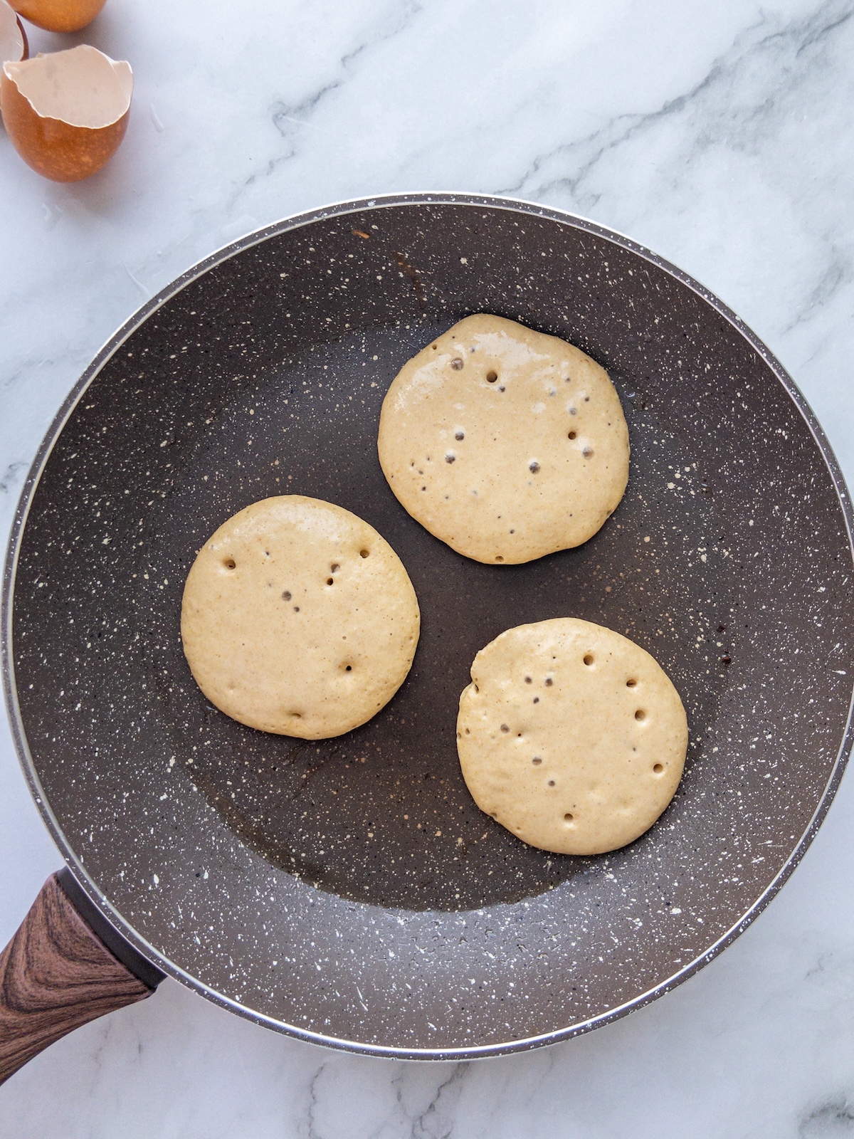 A pan seen frying some banana pancakes
