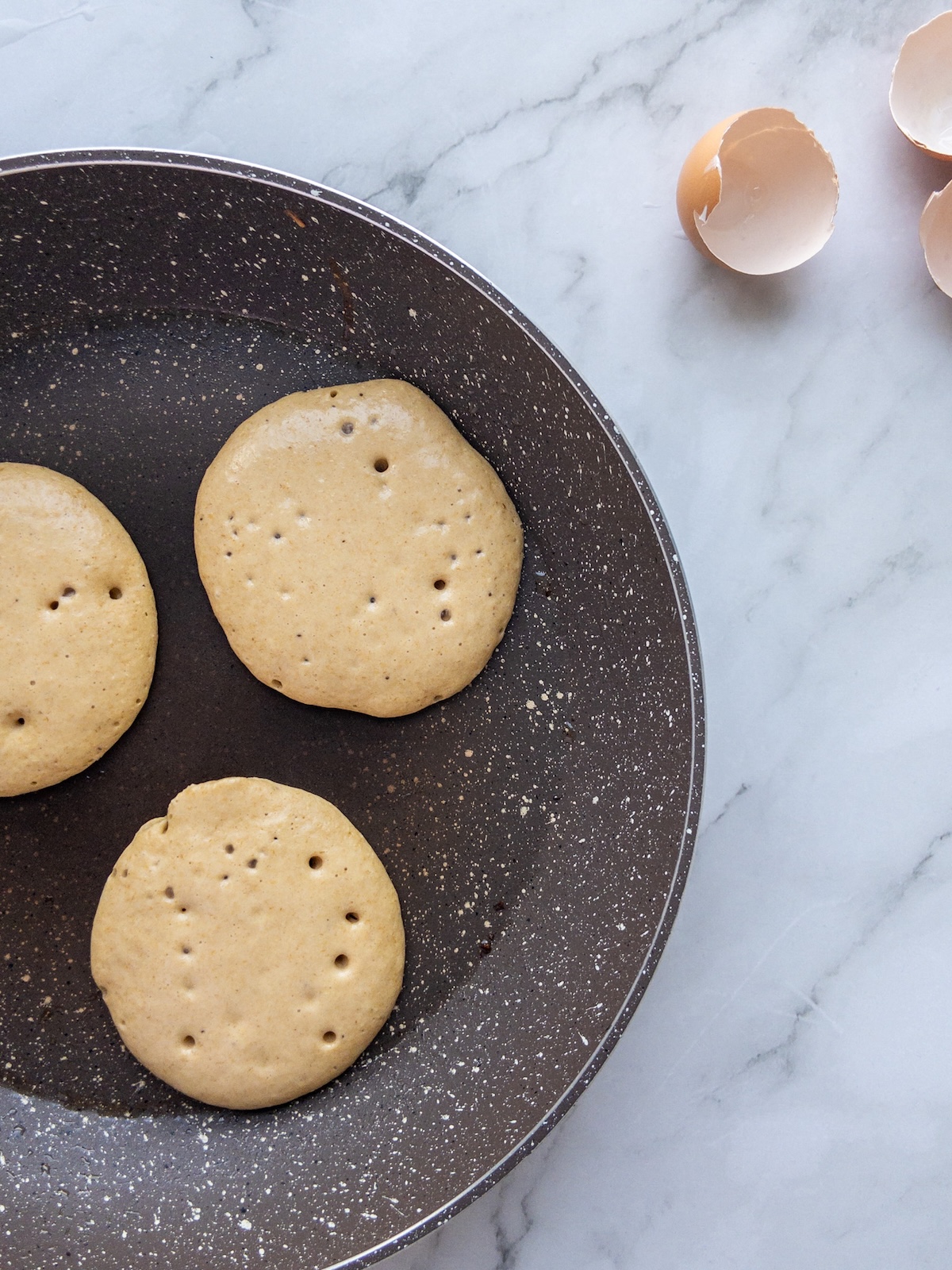 A pan seen frying some banana pancakes