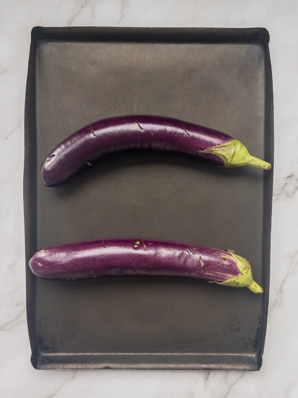 two chinese eggplants placed on a tray
