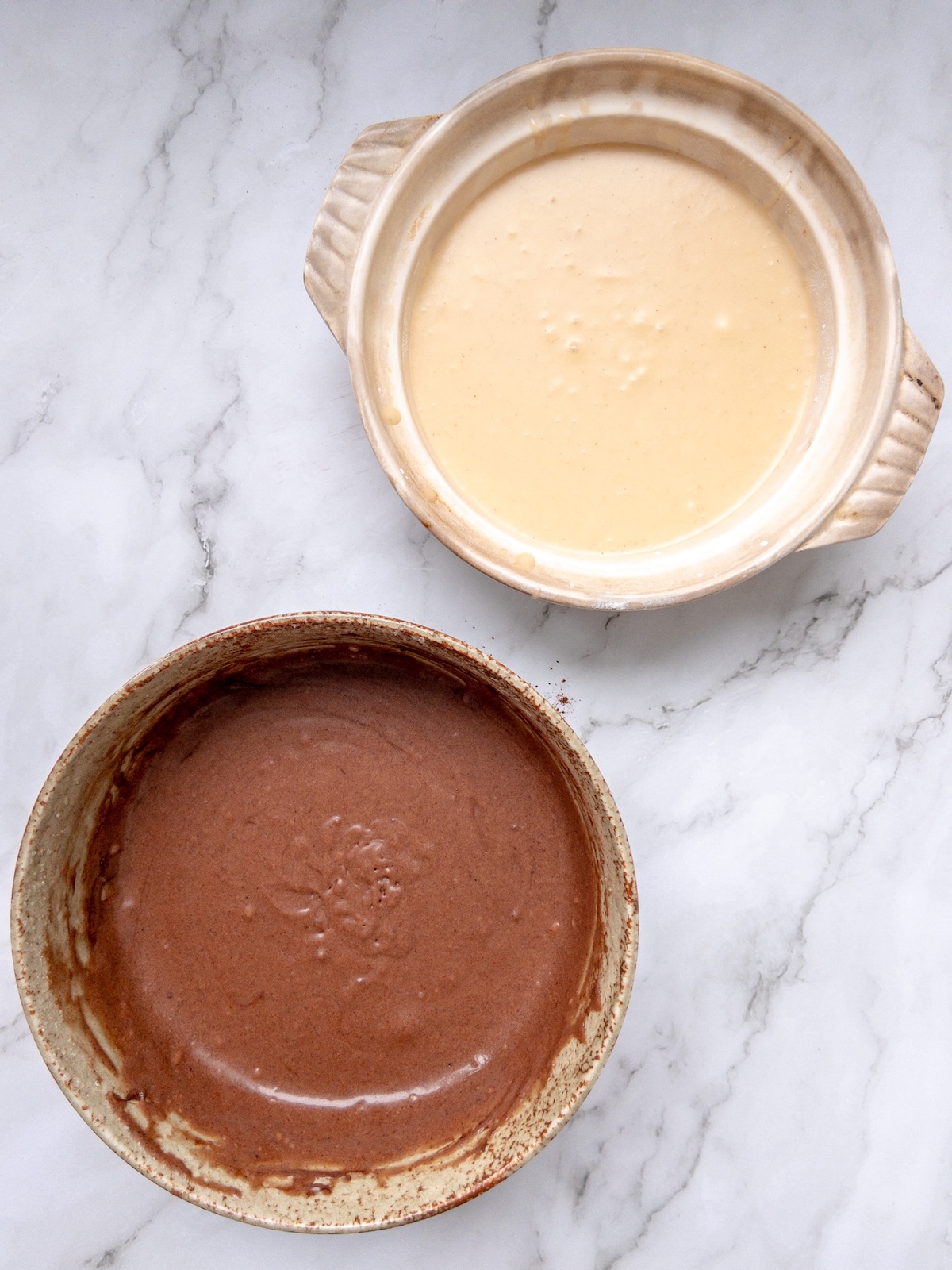 Vanilla and chocolate marbled cake batter split into two bowls