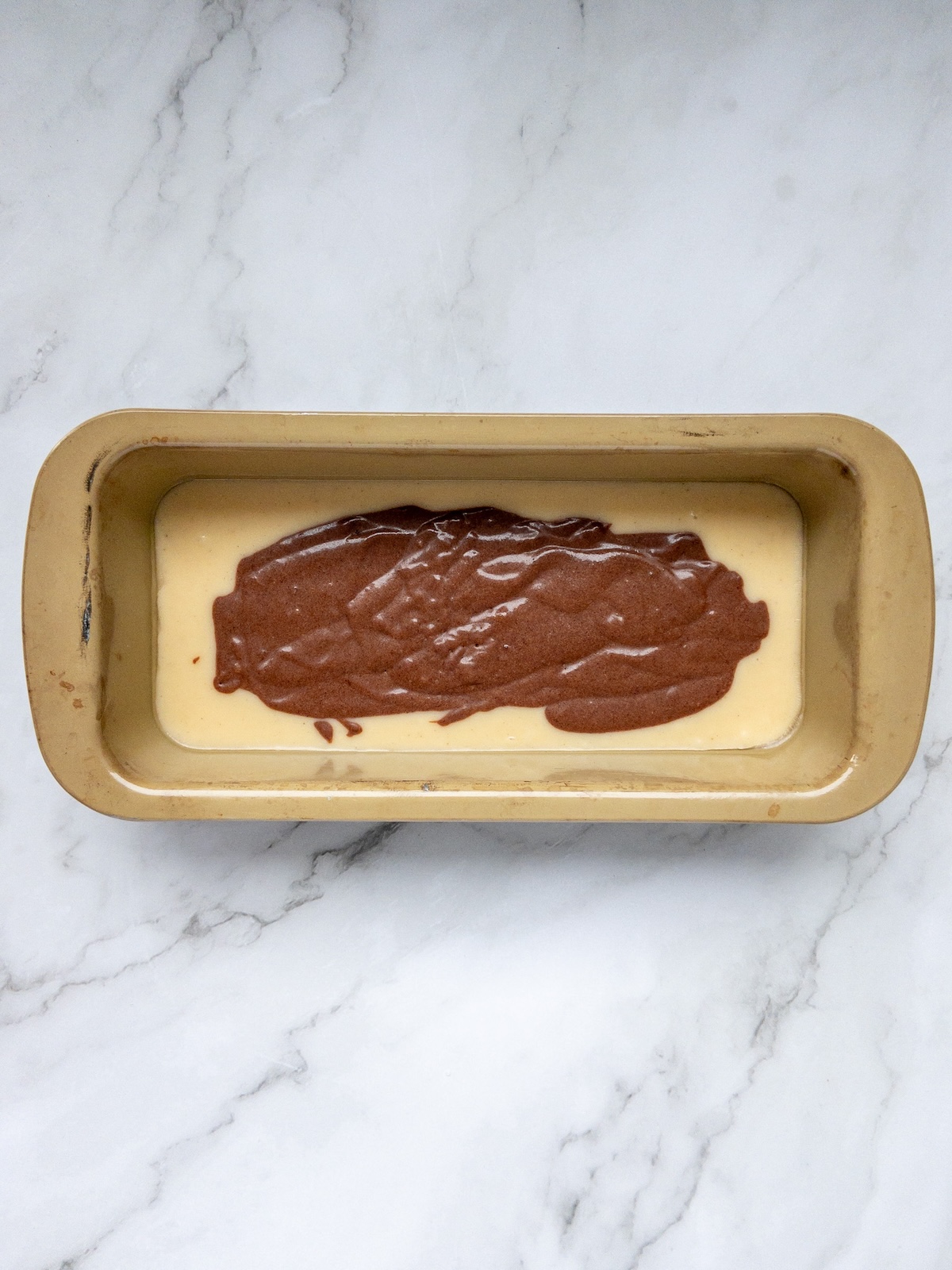 Vanilla and chocolate marbled cake batter layered