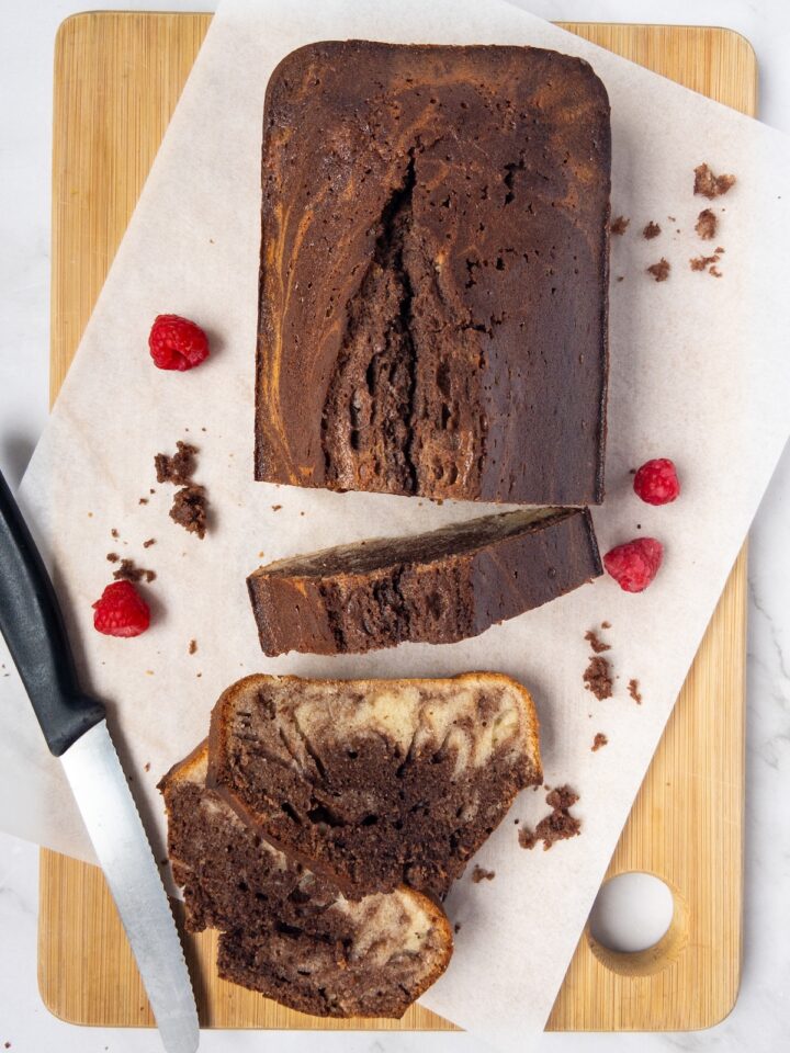 Vanilla and chocolate marbled cake slices on a wooden board