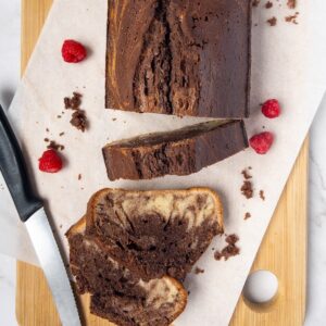 Vanilla and chocolate marbled cake slices on a wooden board
