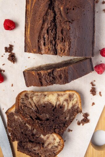 Vanilla and chocolate marbled cake slices on a wooden board
