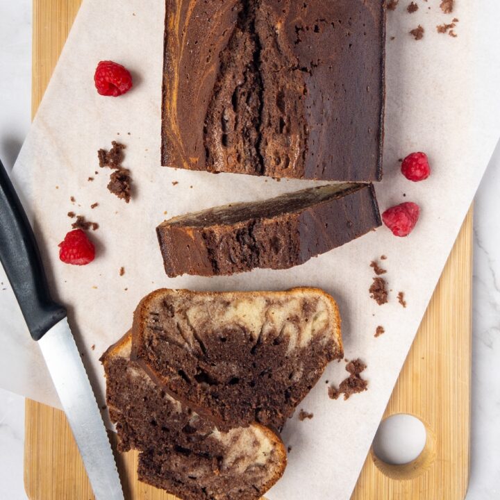 Vanilla and chocolate marbled cake slices on a wooden board