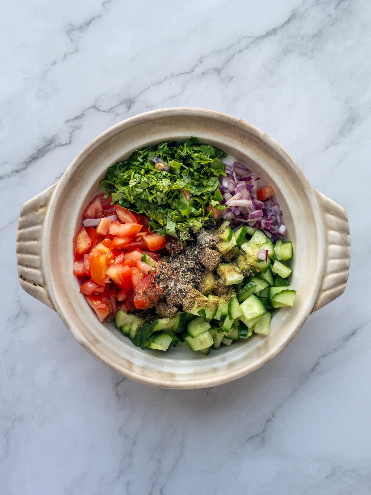 Ingredients about to be mixed in a bowl for mixed raita