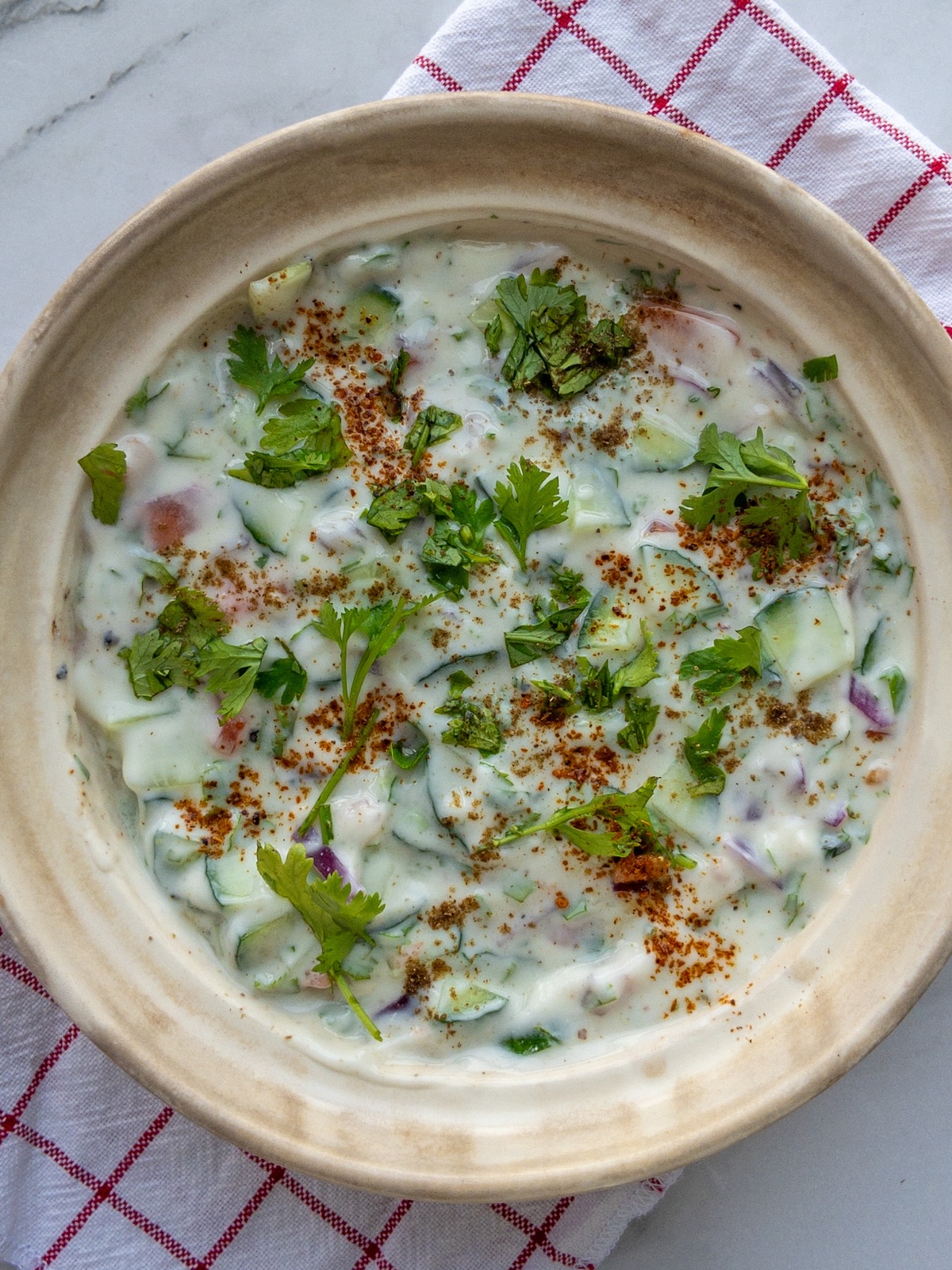 Close up of mixed vegetable raita served in a bowl