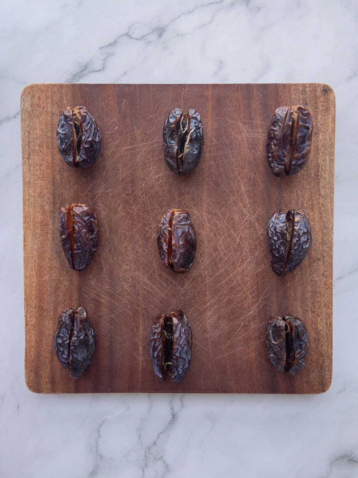 dates slit open on a board with the pits removed
