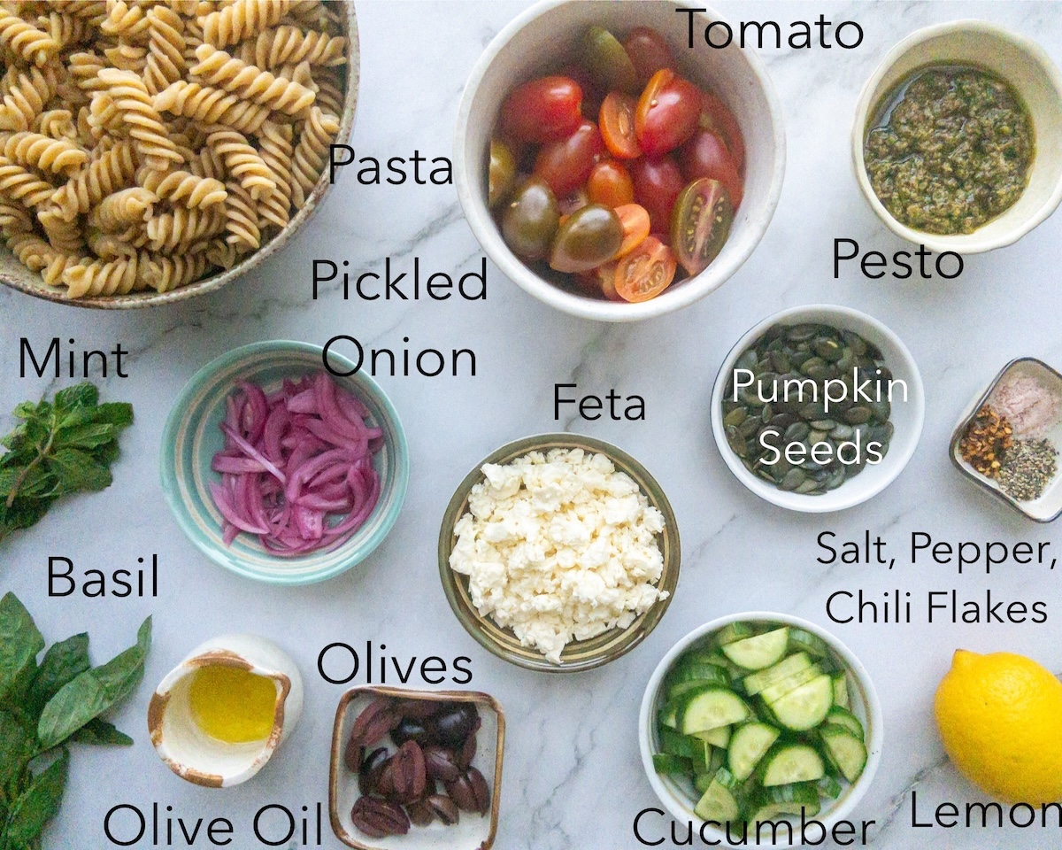 Ingredients for Pesto pasta salad served in bowls