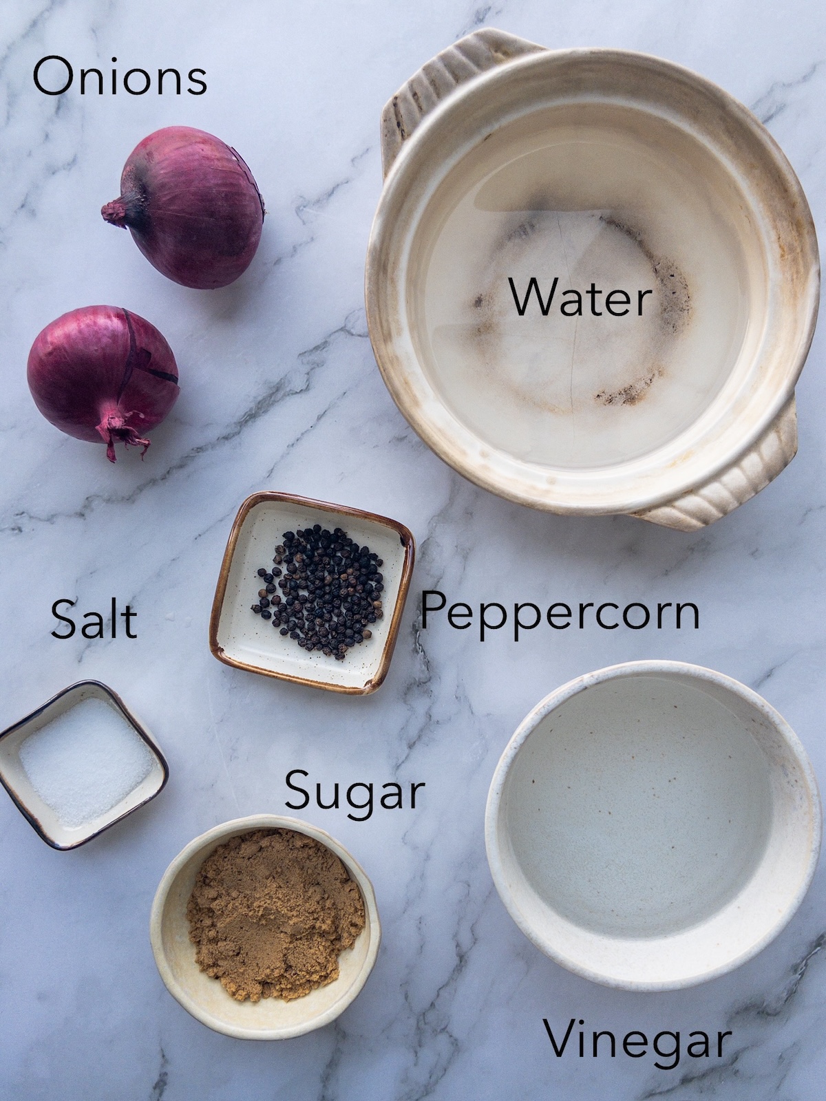 Ingredients for pickled red onions in small bowls
