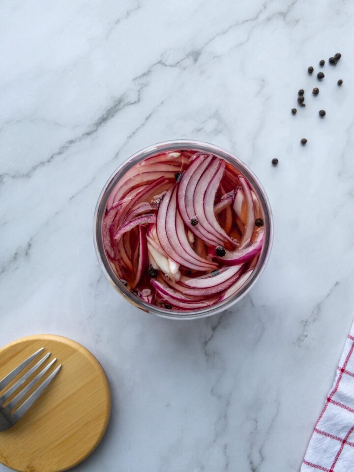 Pickled red onions in a glass jar top view