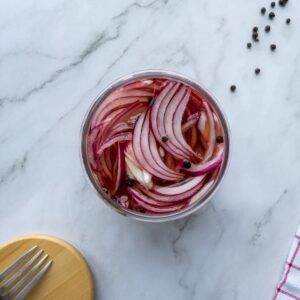Pickled red onions in a glass jar top view