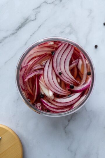 Pickled red onions in a glass jar top view