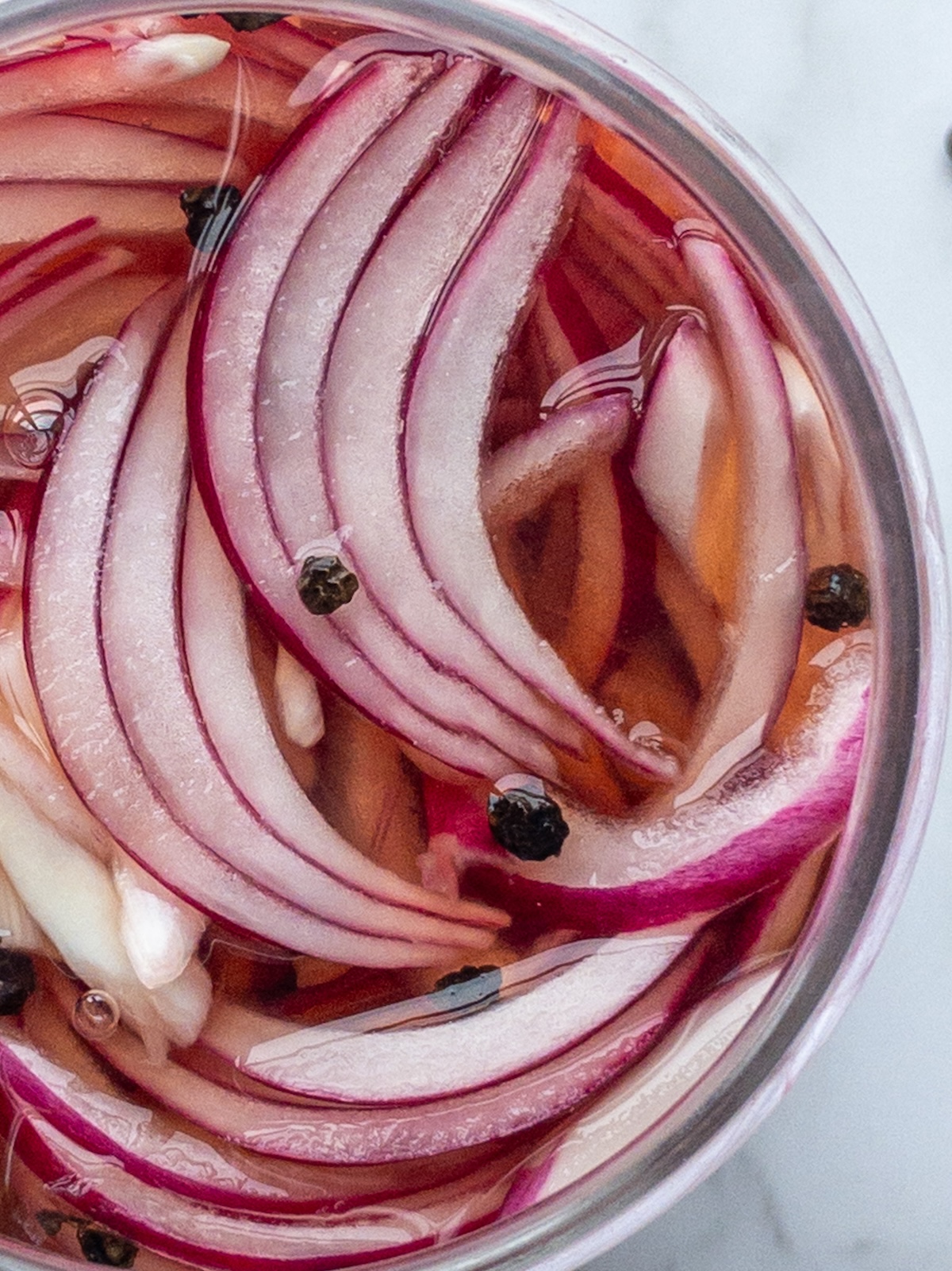 close up of Pickled red onions in a glass jar