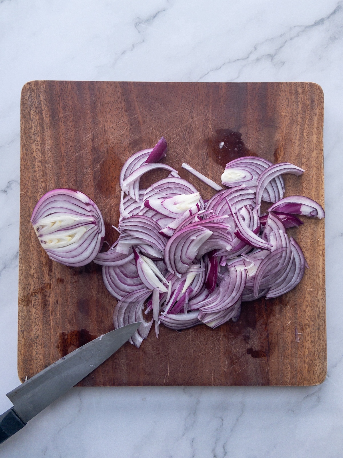 Red onions chopped on a wooden cutting board