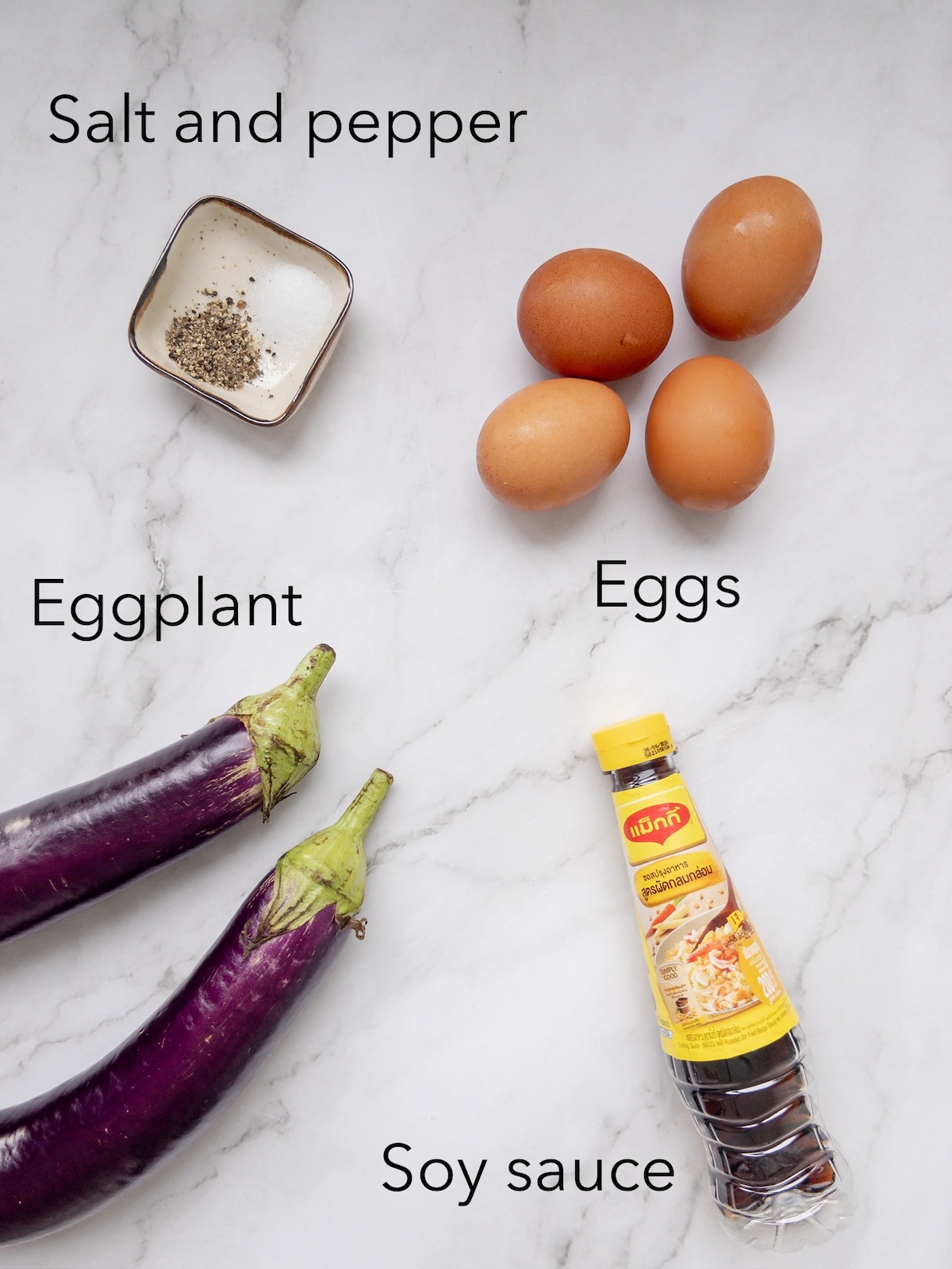 Ingredients for tortang talong, including eggplant and eggs