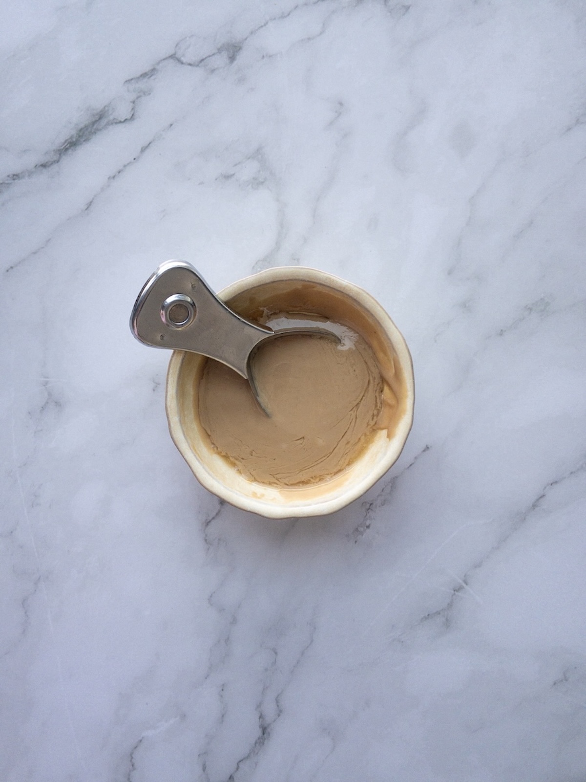 tahini mixed with orange juice in a small bowl