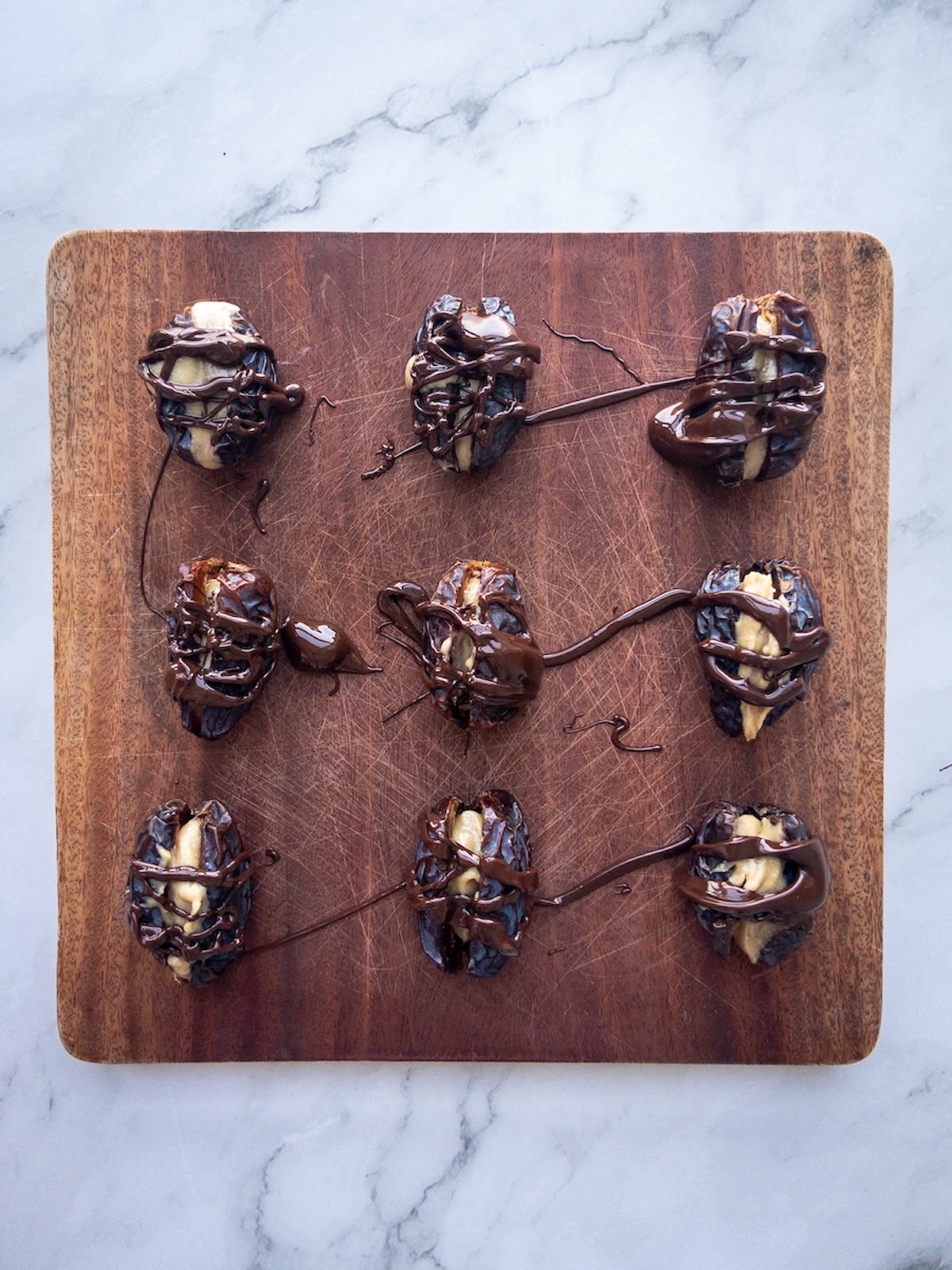 dates stuffed with tahini and topped with melted chocolate