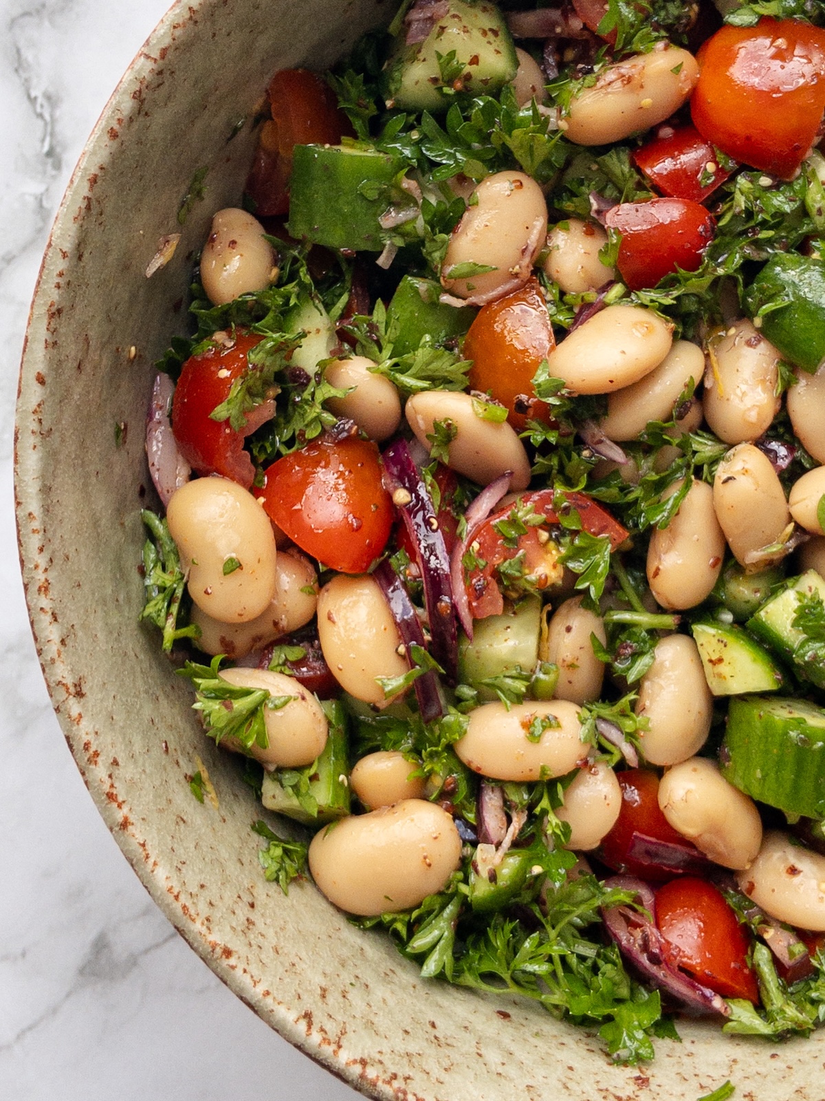 close up of butter beans mixed with vegetables