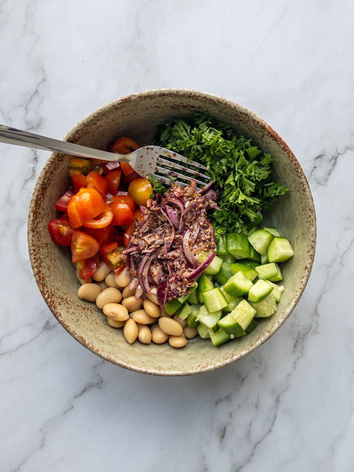 ingredients for butter bean salad placed in a bowl