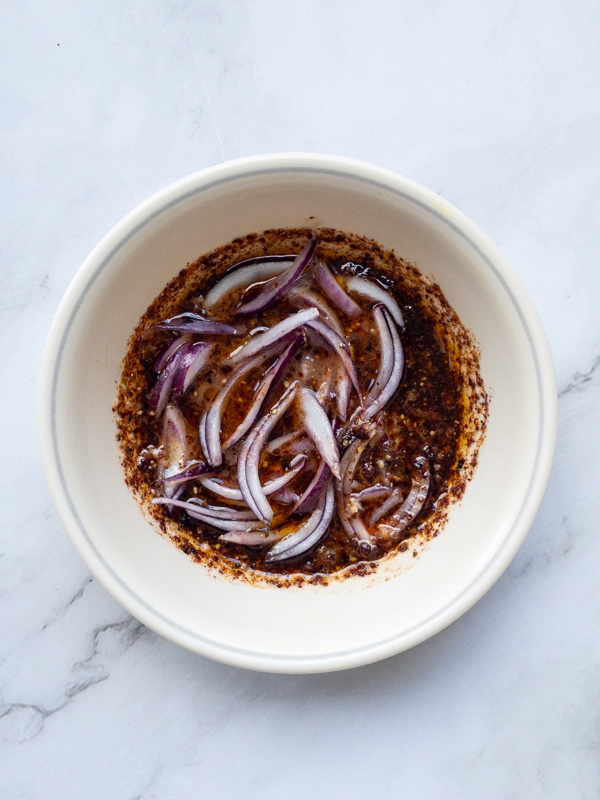onions marinating in a dressing with sumac