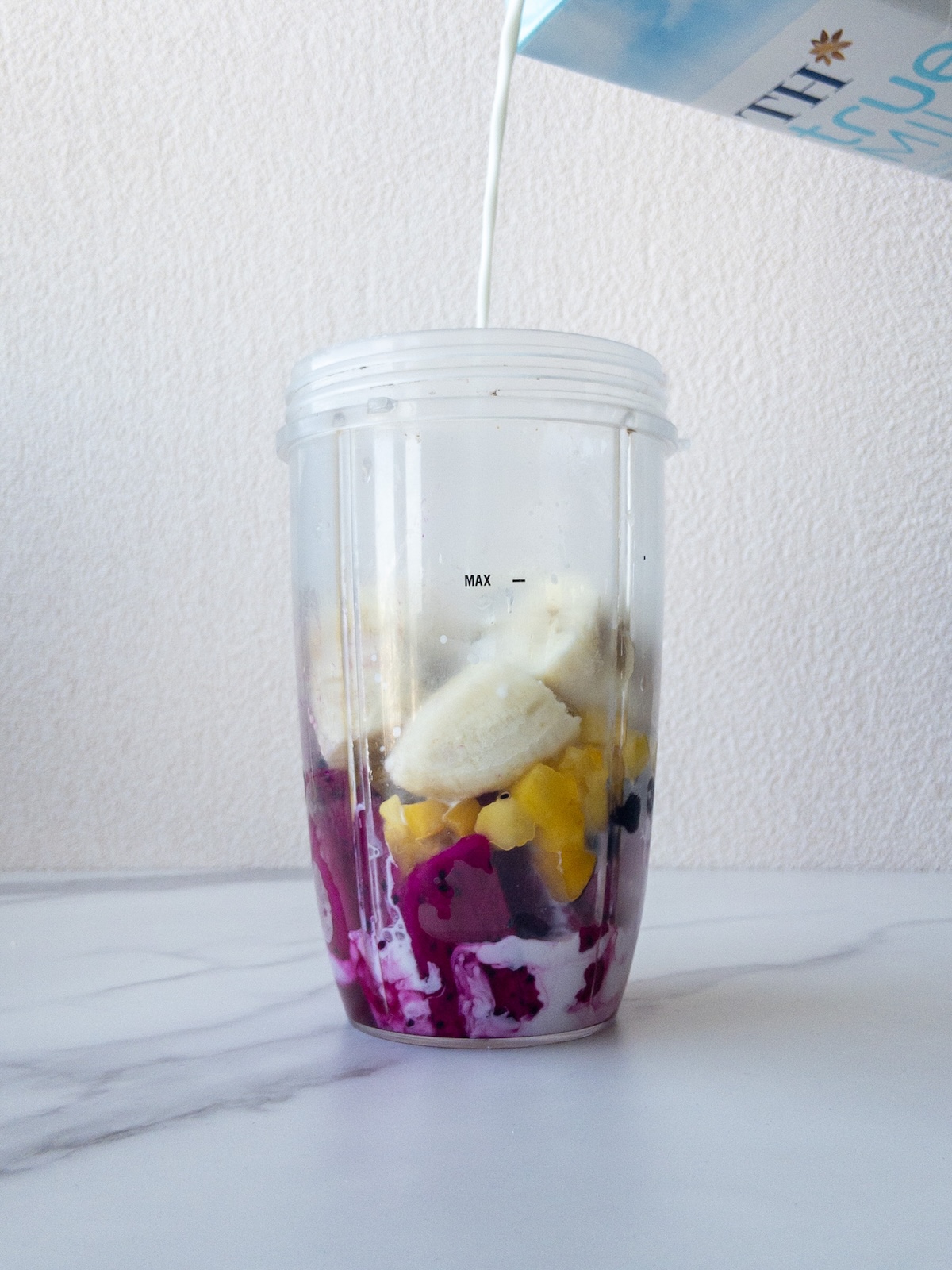 ingredients inside a blender container for a smoothie