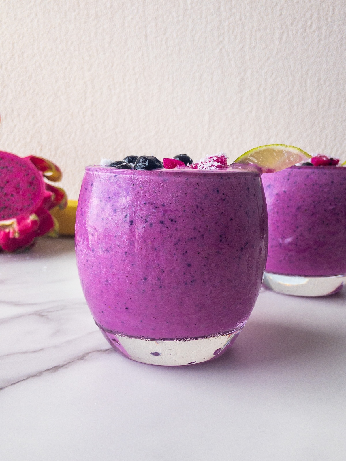 a bright pink smoothie presented in a glass