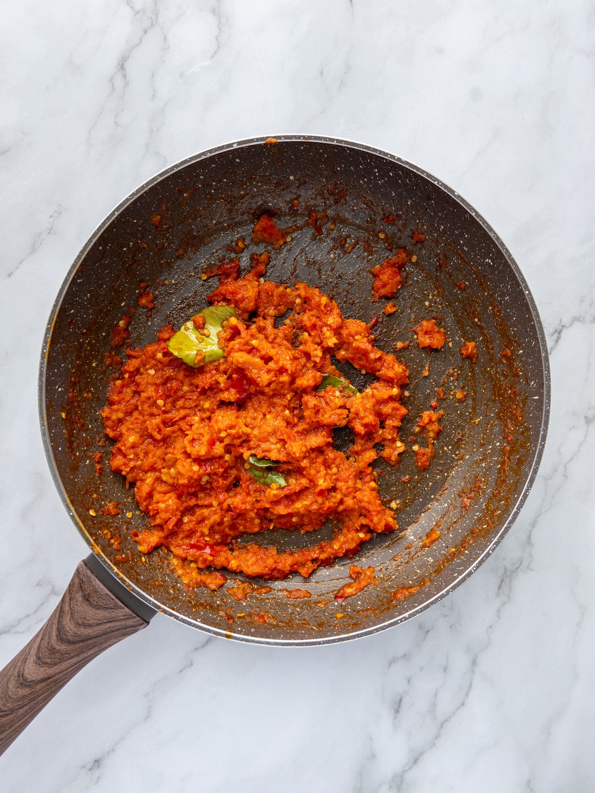 Chili paste being fried in a pan