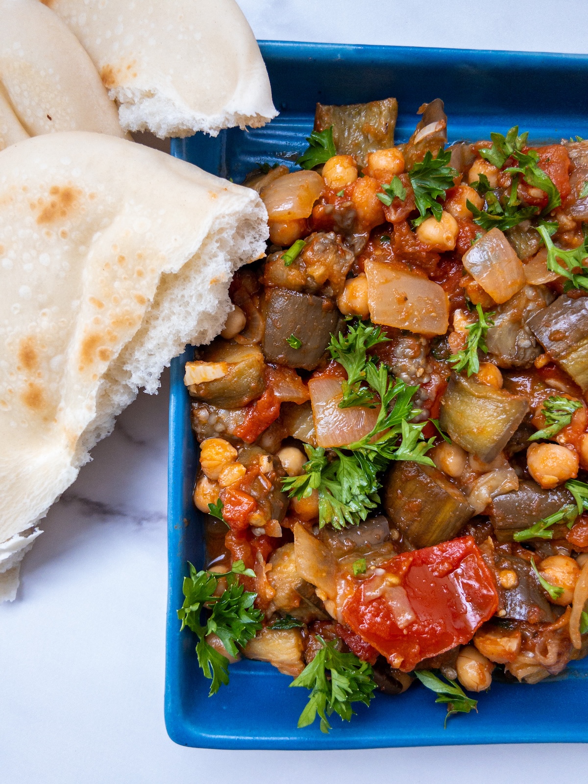 Maghmour, or Lebanese Moussaka served on a plate with pita bread