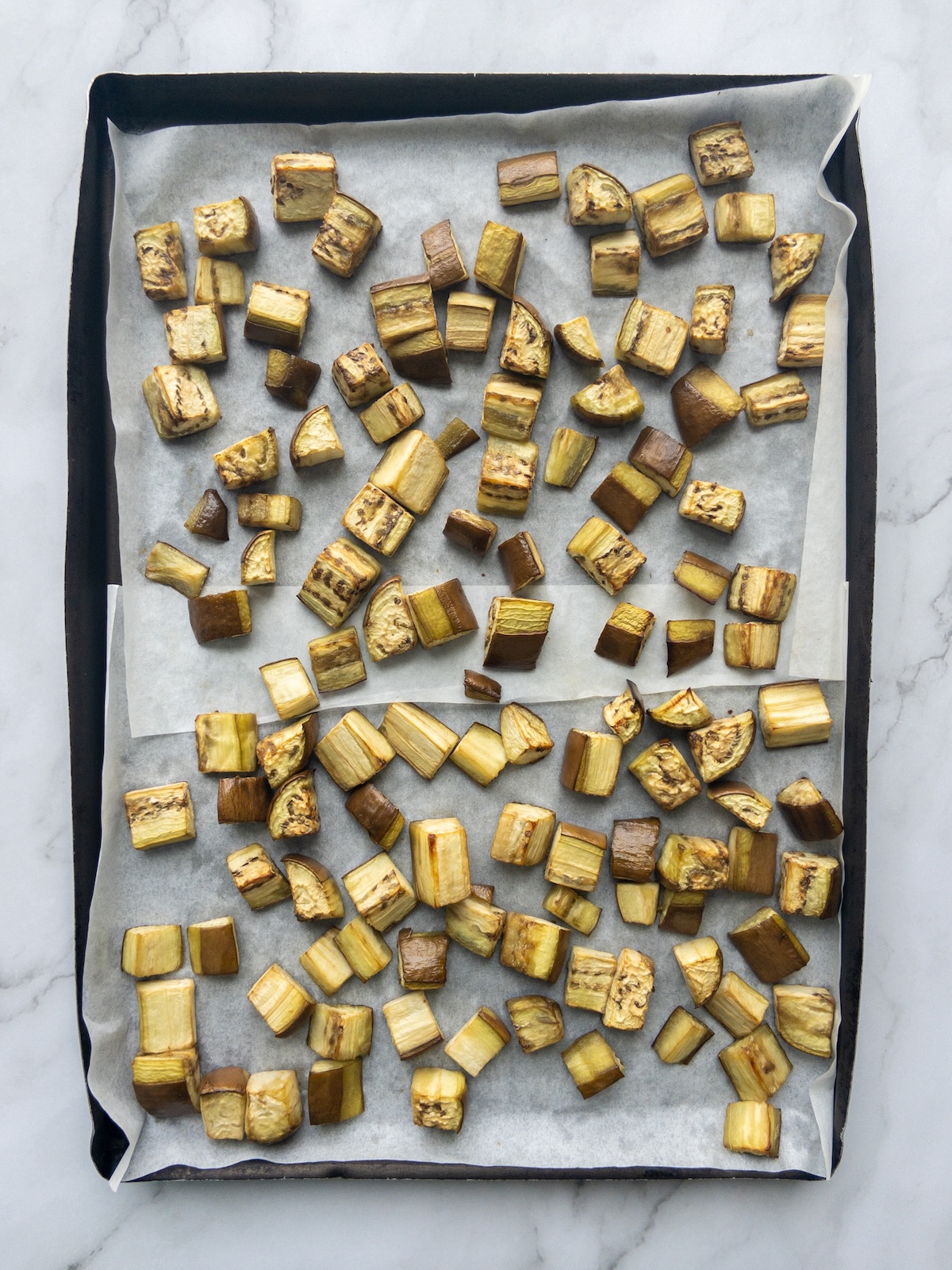 Cubes of eggplant roasted on a tray