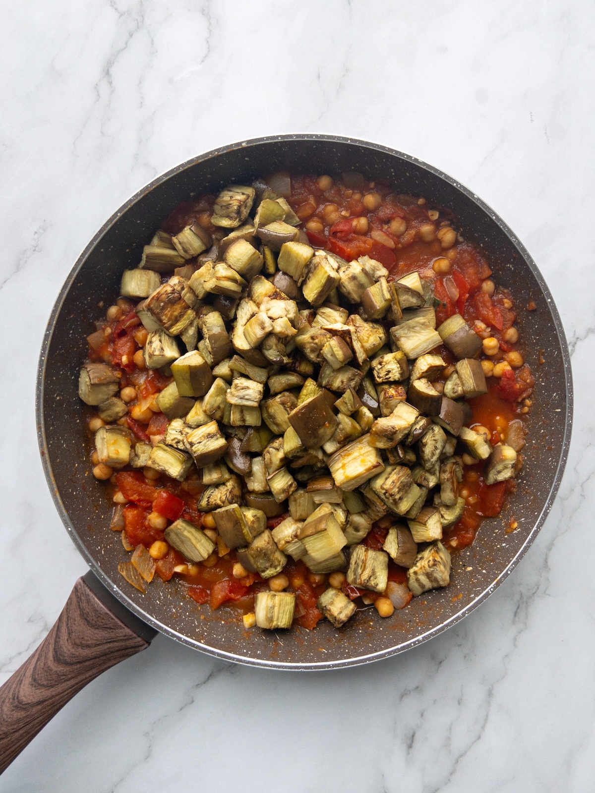 Eggplants added to the tomato sauce for Maghmour
