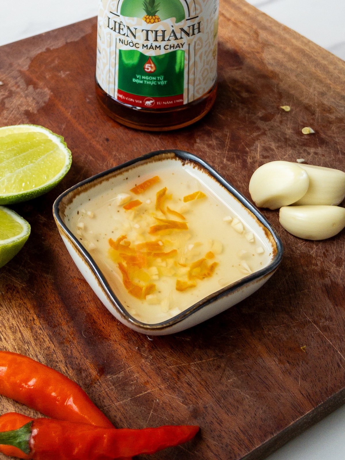 vegan nuoc cham served in a little bowl on a wooden board