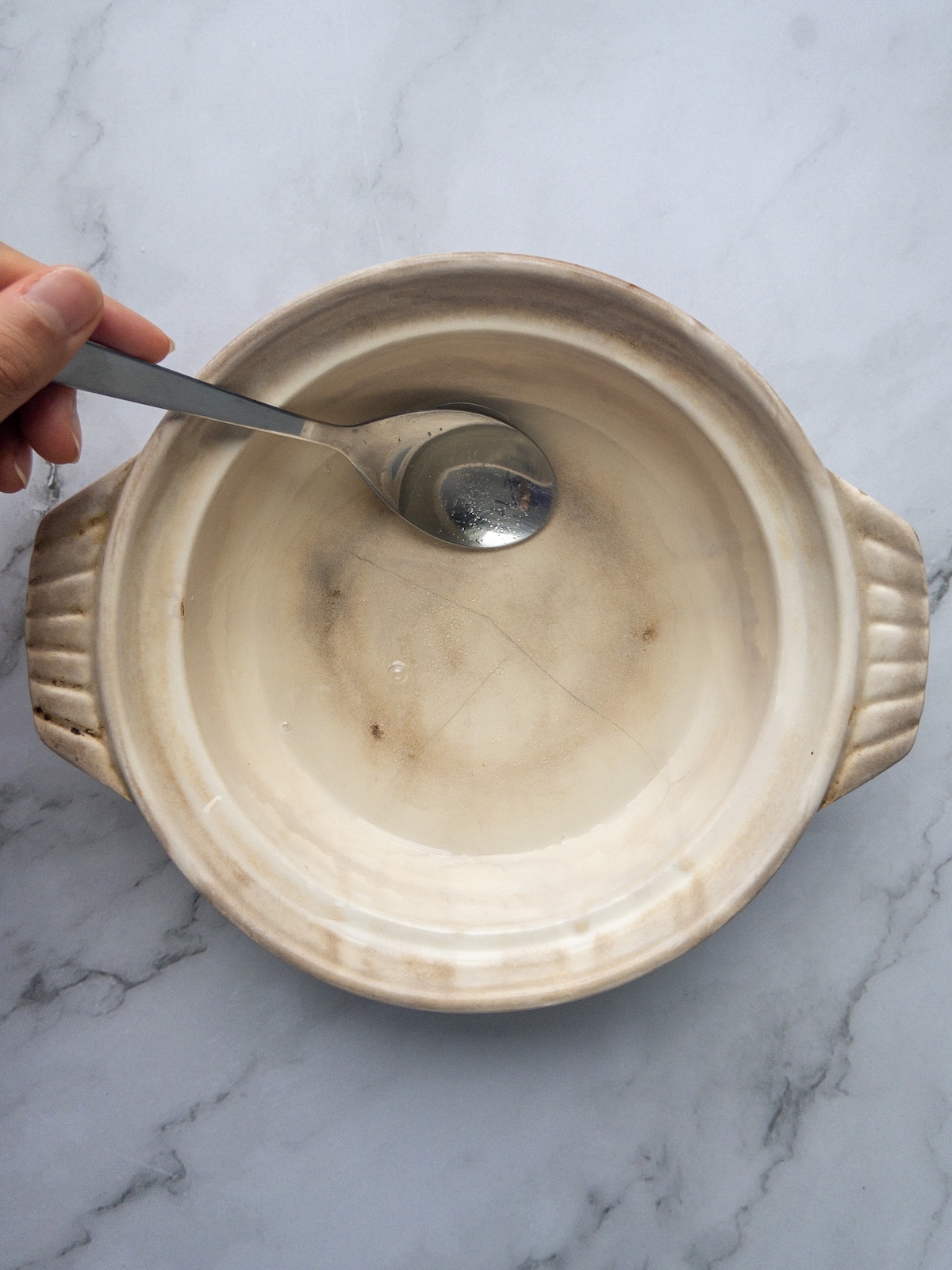 water and sugar being mixed in a bowl on a counter