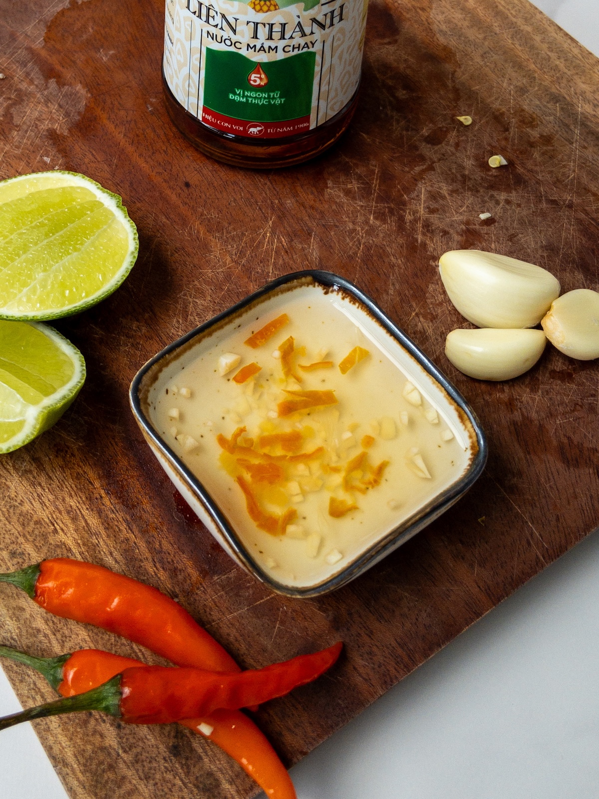 vegan nuoc cham served in a little bowl on a wooden board