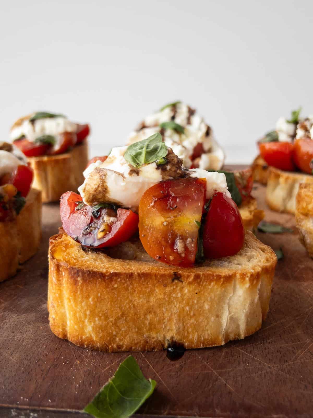 Burrata Bruschetta on a wooden chopping board