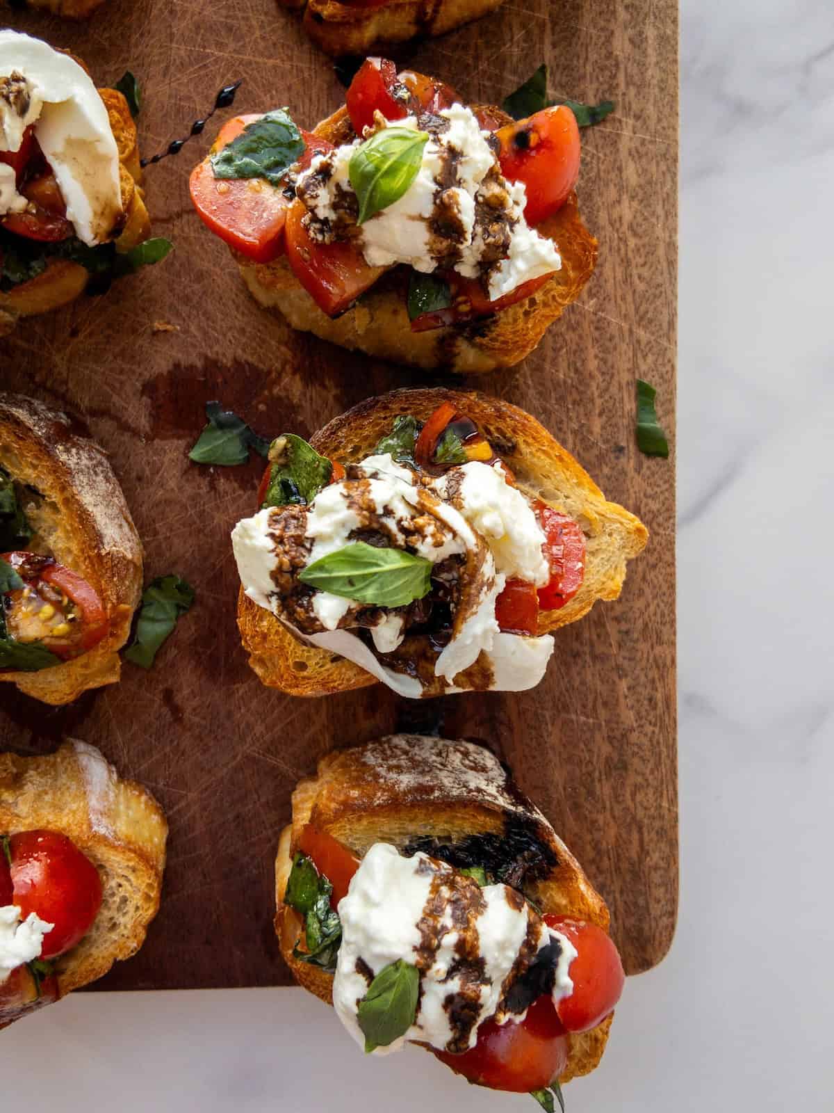 Burrata Bruschetta on a wooden chopping board