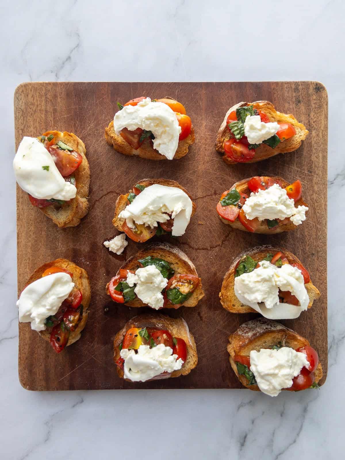 Burrata Bruschetta on a wooden chopping board