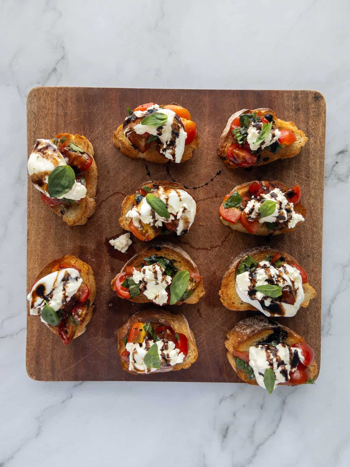 Burrata Bruschetta on a wooden chopping board