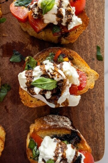 Burrata Bruschetta on a wooden chopping board