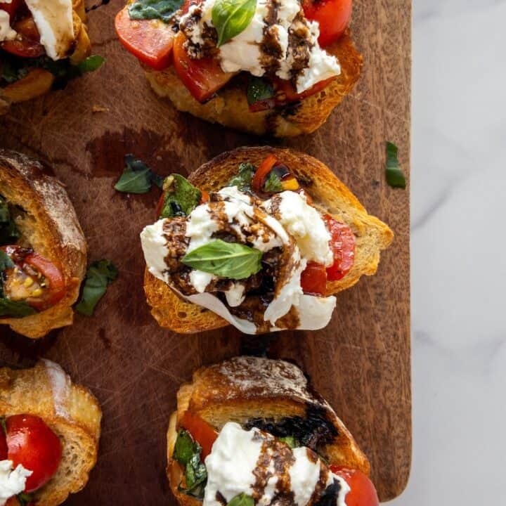 Burrata Bruschetta on a wooden chopping board